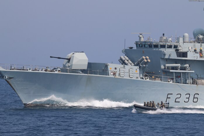 210721-N-N0146-1005 ARABIAN GULF (July 21, 2021) – Royal Navy and U.S. Navy Sailors operate a rigid hull inflatable boat in formation with Royal Navy frigate HMS Montrose (F236) during a multilateral air operations in support of maritime surface warfare (AOMSW) exercise in the Arabian Gulf, July 21. (U.S. Coast Guard photo by Petty Officer 2nd Class Joseph Perrone)