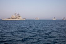 210722-A-UH336-0032 ARABIAN GULF (July 22, 2021) – Guided-missile destroyer USS Mitscher (DDG 57), amphibious transport dock ship USS San Antonio (LPD 17), amphibious dock landing ship USS Carter Hall (LSD 50), and Coast Guard fast response cutter USCGC Charles Moulthrope (WPC 1141) operate in formation during a multilateral air operations in support of maritime surface warfare (AOMSW) exercise in the Arabian Gulf, July 22. Commander, Task Force 55 operates in the U.S. 5th Fleet area of operations in support of naval operations to ensure maritime stability and security in the Central Region, connecting the Mediterranean and Pacific through the western Indian Ocean and three critical chokepoints to the free flow of global commerce. (U.S. Army photo by Spc. Joseph DeLuco)