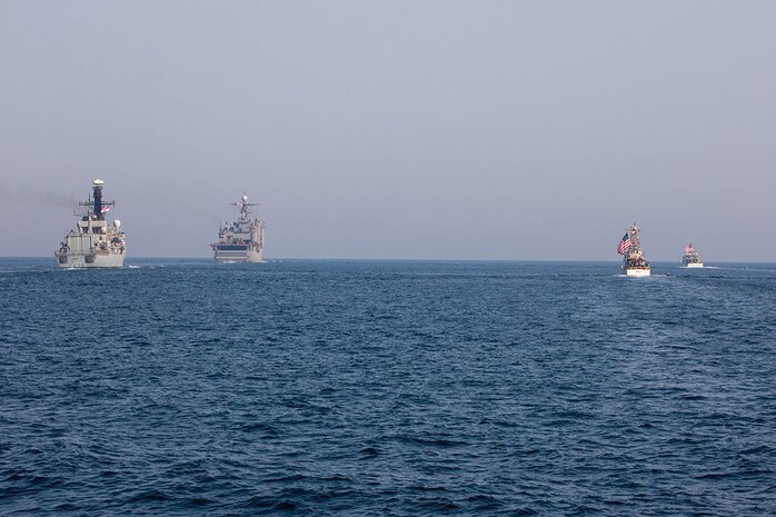 210722-A-UH336-0074 ARABIAN GULF (July 22, 2021) – Royal Navy frigate HMS Montrose (F236), amphibious dock landing ship USS Carter Hall (LSD 50), Coast Guard fast response cutter USCGC Robert Goldman (WPC 1141), and Coast Guard patrol boat USCGC Monomoy (WPB 1326) operate in formation during a multilateral air operations in support of maritime surface warfare (AOMSW) exercise in the Arabian Gulf, July 22. Commander, Task Force 55 operates in the U.S. 5th Fleet area of operations in support of naval operations to ensure maritime stability and security in the Central Region, connecting the Mediterranean and Pacific through the Western Indian Ocean and three critical chokepoints to the free flow of global commerce. (U.S. Army photo by Spc. Joseph DeLuco)