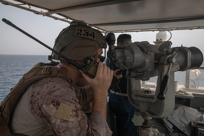 210722-A-UH336-0089 ARABIAN GULF (July 22, 2021) – Marine Cpl. Robert Van Pelt, observes targets aboard patrol coastal ship USS Tempest (PC 2) during a multilateral air operations in support of maritime surface warfare (AOMSW) exercise in the Arabian Gulf, July 22. Commander, Task Force 55 operates in the U.S. 5th Fleet area of operations in support of naval operations to ensure maritime stability and security in the Central Region, connecting the Mediterranean and Pacific through the western Indian Ocean and three critical chokepoints to the free flow of global commerce. (U.S. Army photo by Spc. Joseph DeLuco)