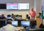 (July 27, 2021)  David Rollo, U.S. Naval Forces Europe-Africa maritime domain awareness program manager, provides the joint operations center personnel with a brief on SeaVision during exercise Cutlass Express 2021, in Mombasa, Kenya, July 27, 2021. Cutlass Express is designed to improve regional cooperation, maritime domain awareness and information sharing practices to increase capabilities between the U.S., East African and Western Indian Ocean nations to counter illicit maritime activity.