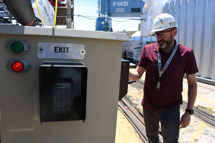 Norfolk Naval Shipyard’s (NNSY) new Ship Access System (SAS) provides real-time accountability of personnel onboard vessels and is integrated with the shipyard’s existing automated access control system. The access control system works by utilizing a machine called the Badge Access Box (BAB).  As individuals enter and exit the ship, they will scan their Common Access Card (CAC) at the access box, with colored light indicators displaying access status.