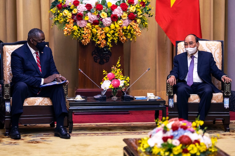 The U.S. Defense Secretary sits next to Vietnam's president during official discussions.