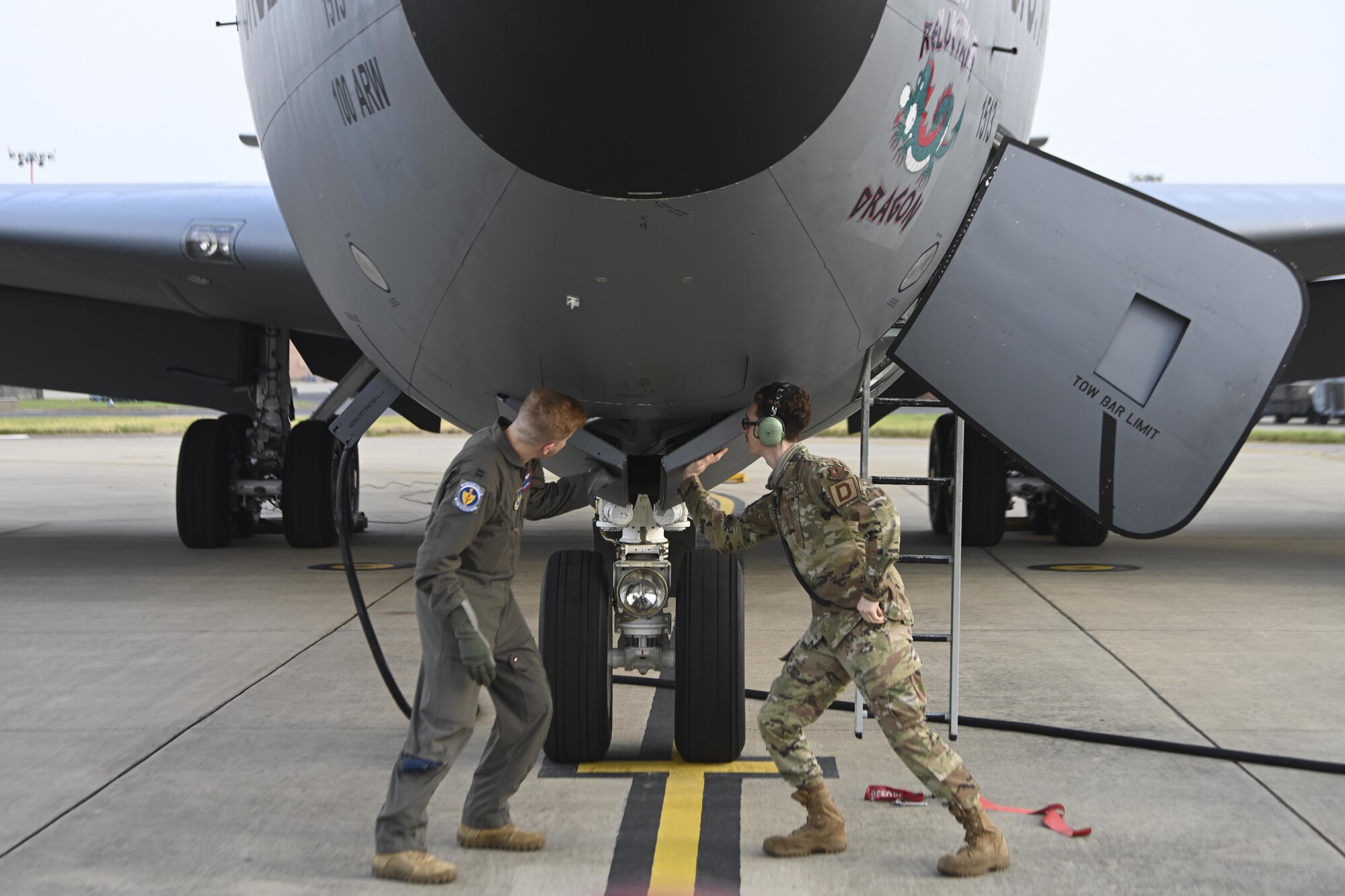 U.S. Air Force Capt. William Carroll, 351st Air Refueling Squadron pilot, left, and an Airman assigned to the 100th Aircraft Maintenance Squadron push an aircraft panel into place before flight at Royal Air Force Mildenhall, England, July 27, 2021. The 100th Air Refueling Wing provides the critical air refueling “bridge” that allows the Air Force to deploy around the globe at a moment’s notice. (U.S. Air Force photo by Senior Airman Joseph Barron)