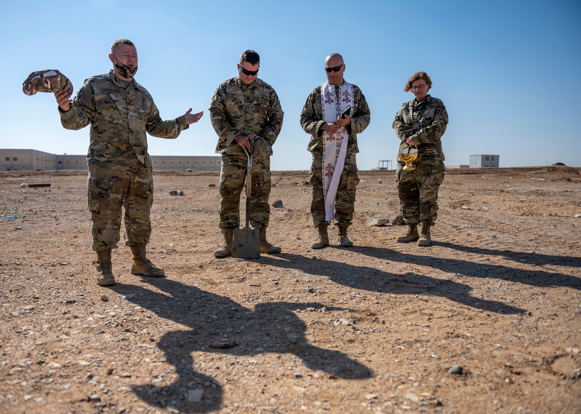 U.S. Airmen pray at ground breaking site