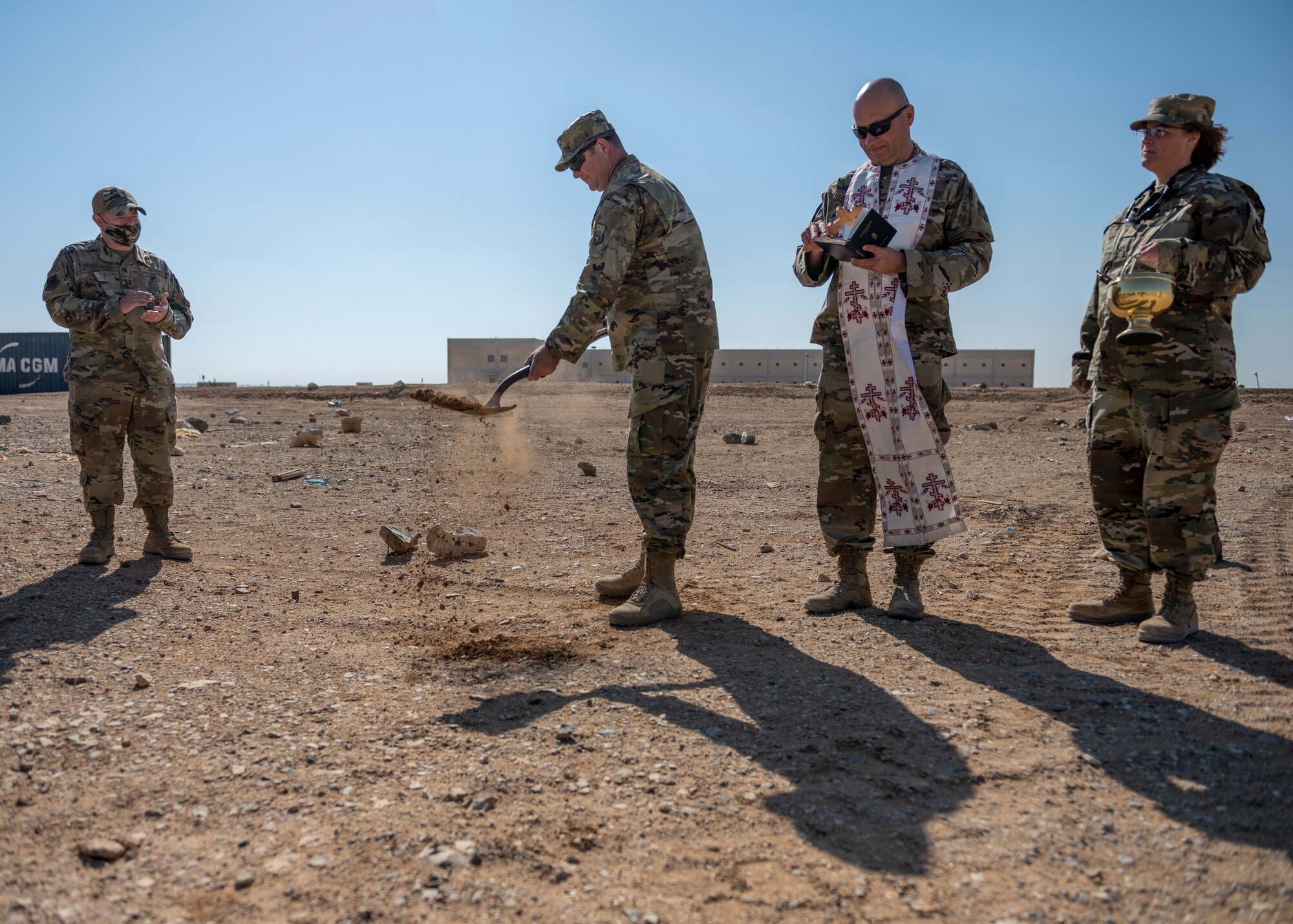 U.S. Air Force chaplain digs dirt with a shovel