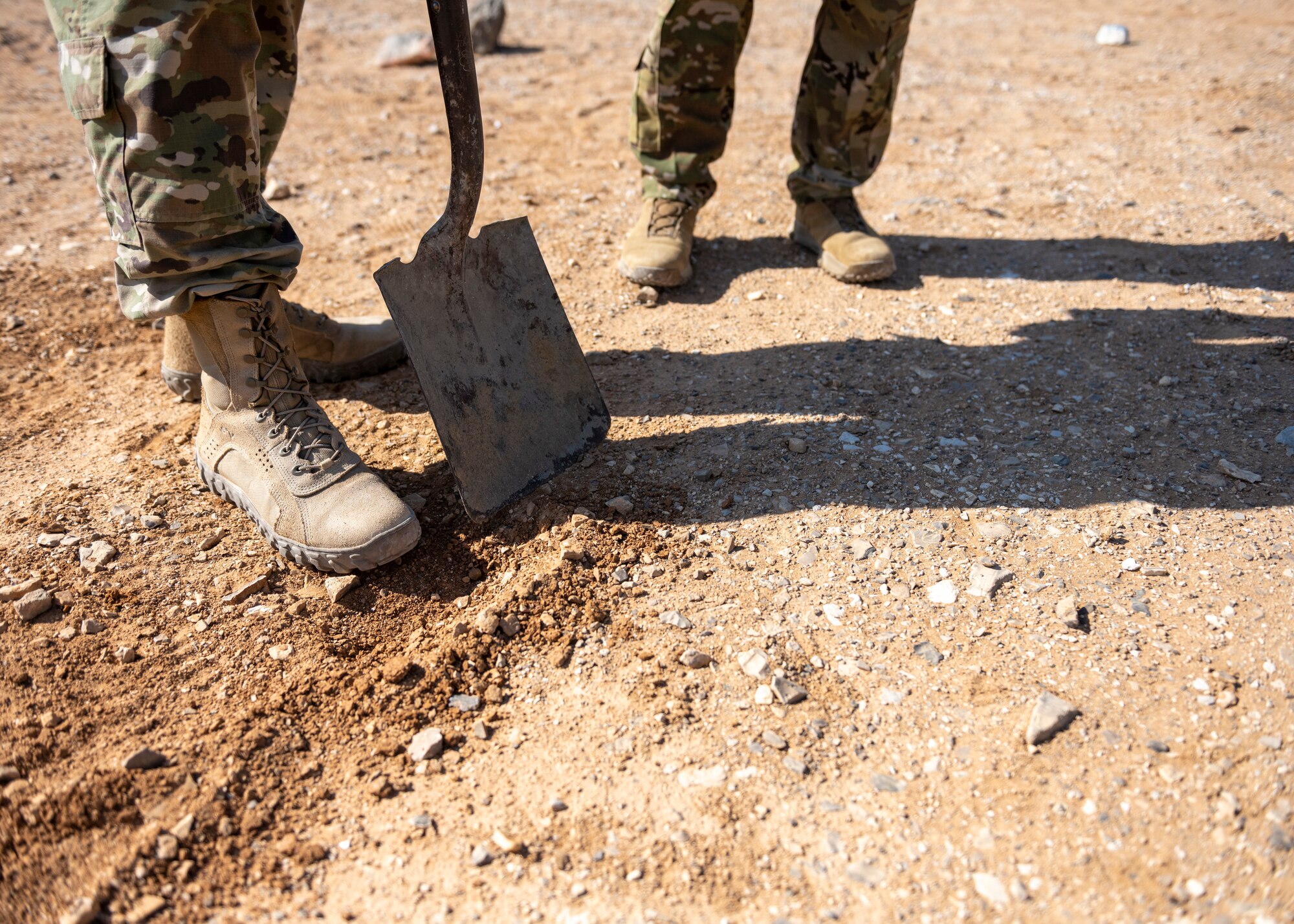 U.S. Airmen's boots next to a shovel