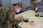 Army 1st Lt. Joan Emerson of Charlie Company, 186th Brigade Support Battalion, records the hospital beds that are part of each medical pod at the Alternate Healthcare Facility in Essex, Vermont, on April 7th, 2020. The Vermont National Guard is working with the state of Vermont and emergency partners in a whole-of-government effort to flatten the curve during the COVID-19 pandemic. (U.S. Army National Guard photo by Cpl. Gillian McCreedy)