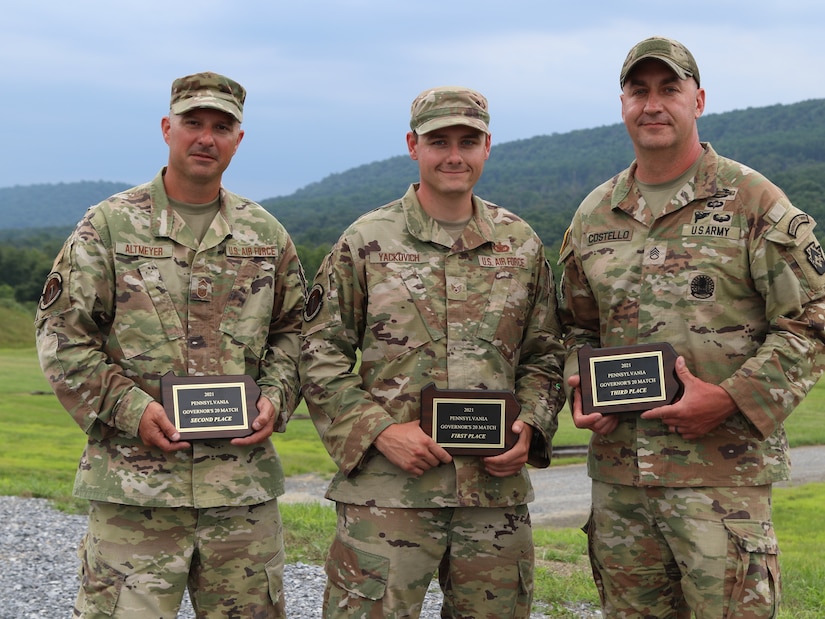 The top three winners of the 2021 Governor’s Twenty competition celebrate their achievement July 24 at Fort Indiantown Gap. Staff Sgt. Nicholas Yackovich (center), with the 171st Security Forces Squadron, 171st Air Refueling Wing, Pennsylvania Air National Guard of Harrison City, Pa.; Chief Master Sgt. Edwards Altmeyer (left), with the 171st SFS of Coraopolis, Pa.; and Staff Sgt. Douglas Costello (right), with the 213th Personnel Company, 213th Regional Support Group, Pennsylvania Army National Guard of Mountain Top, Pa., placed first, second and third. Eighty-three Pennsylvania National Guard Soldiers and Airmen competed with rifles and pistols in multiple courses of fire to determine the Commonwealth’s best marksmen during the Governor’s Twenty match July 23-24. (U.S. Army National Guard photo by Spc. Vail Forbeck)