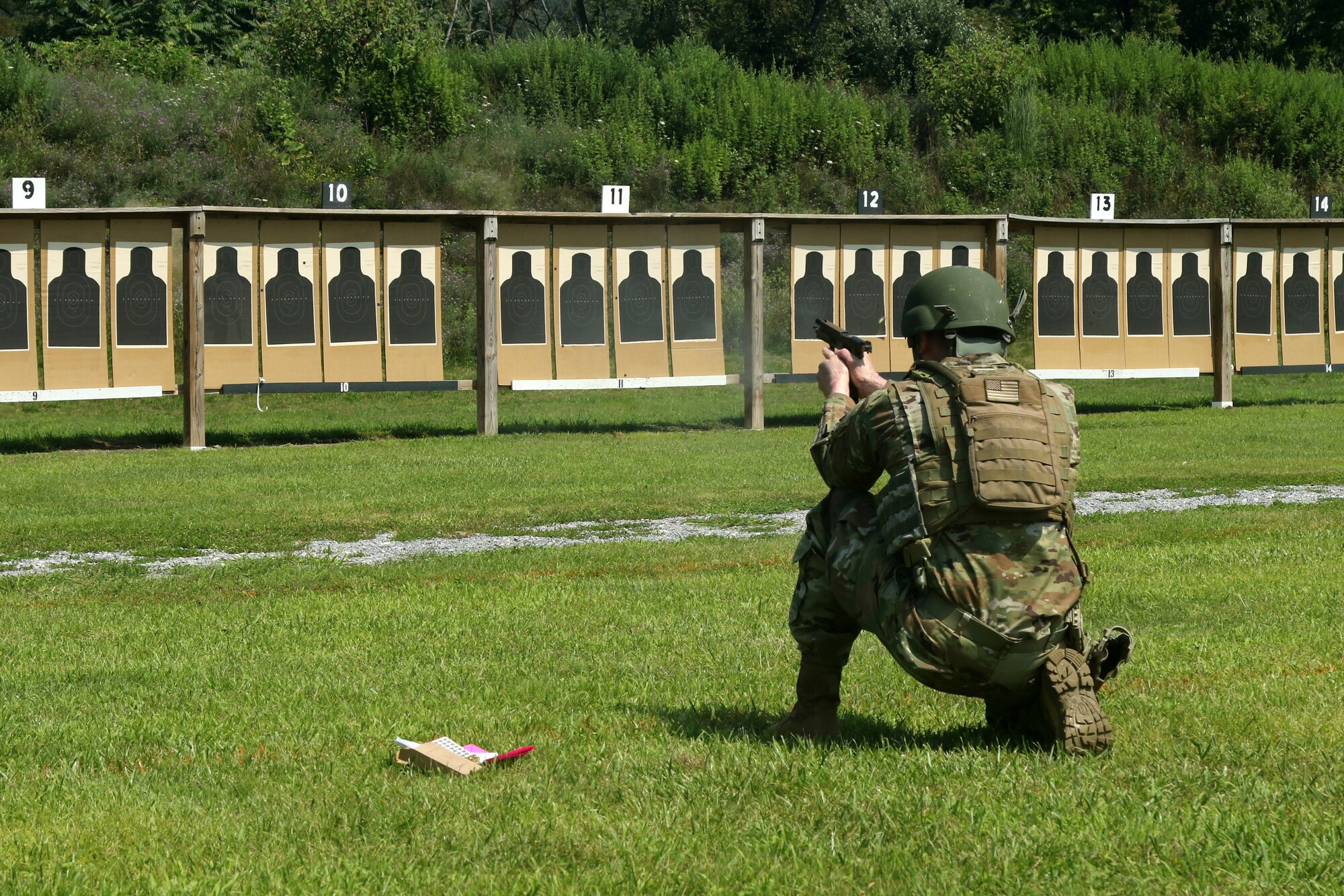 Sgt. William A. Varee, assigned to Headquarters and Headquarters Company, 1st Battalion, 112th Infantry Regiment, 56th Stryker Brigade Combat Team, 28th Infantry Division, Pennsylvania Army National Guard, kneels to fire his pistol at the Governor’s Twenty Match July 24 at Fort Indiantown Gap. The annual competition awards the Governor’s Twenty Tab to the twenty highest-scoring rifle and pistol competitors from across the state of Pennsylvania. (U.S. Army National Guard photo by 1st Lt. Leanne Demboski)