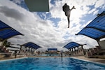 (July 28, 2021) A Mozambique Sailor jumps off a high dive as part of water survival training during exercise Cutlass Express 2021 at the Bandari Maritime Academy in Mombasa, Kenya, July 28, 2021. Cutlass Express is designed to improve regional cooperation, maritime domain awareness and information sharing practices to increase capabilities between the U.S., East African and Western Indian Ocean nations to counter illicit maritime activity.