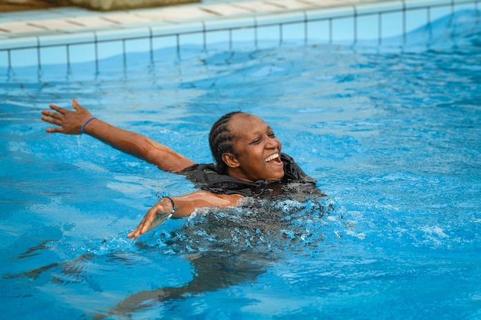 (July 28, 2021) A Comoros Sailor celebrates after jumping off a high dive during the water survival training portion of exercise Cutlass Express 2021 at the Bandari Maritime Academy in Mombasa, Kenya, July 28, 2021. Cutlass Express is designed to improve regional cooperation, maritime domain awareness and information sharing practices to increase capabilities between the U.S., East African and Western Indian Ocean nations to counter illicit maritime activity.