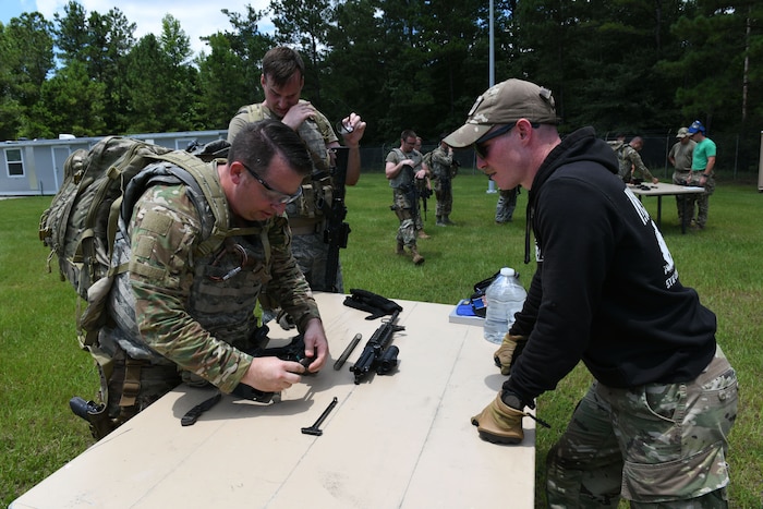 Military member assembles a rifle