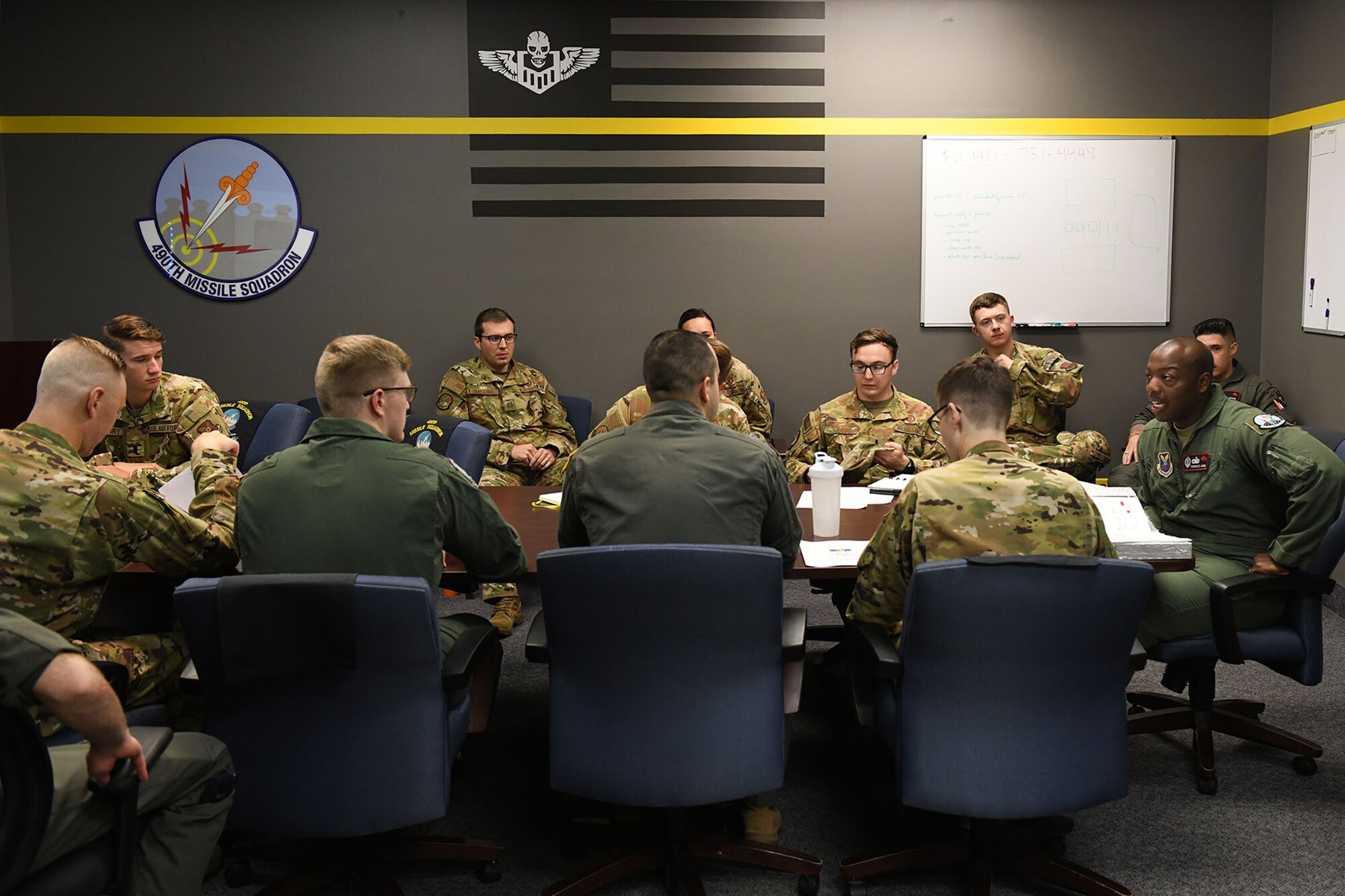 Missileers from the 12th Missile Squadron attend a deployment briefing in preparation to travel to the missile field July 21, 2021, at Malmstrom Air Force Base, Mont.