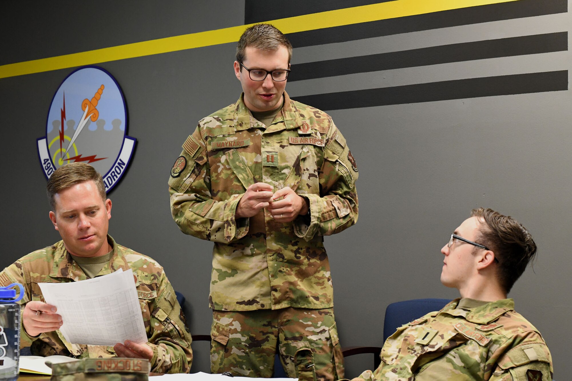 Capt. Alexander Maynard, center, 12th Missile Squadron intercontinental ballistic missile combat crew commander, briefs 12th MS ICBM combat crew members 2nd Lt. Jacob Wallace, left, and 1st Lt. Braxton Stocking, right, on their upcoming missile field deployment July 21, 2021, at Malmstrom Air Force Base, Mont.