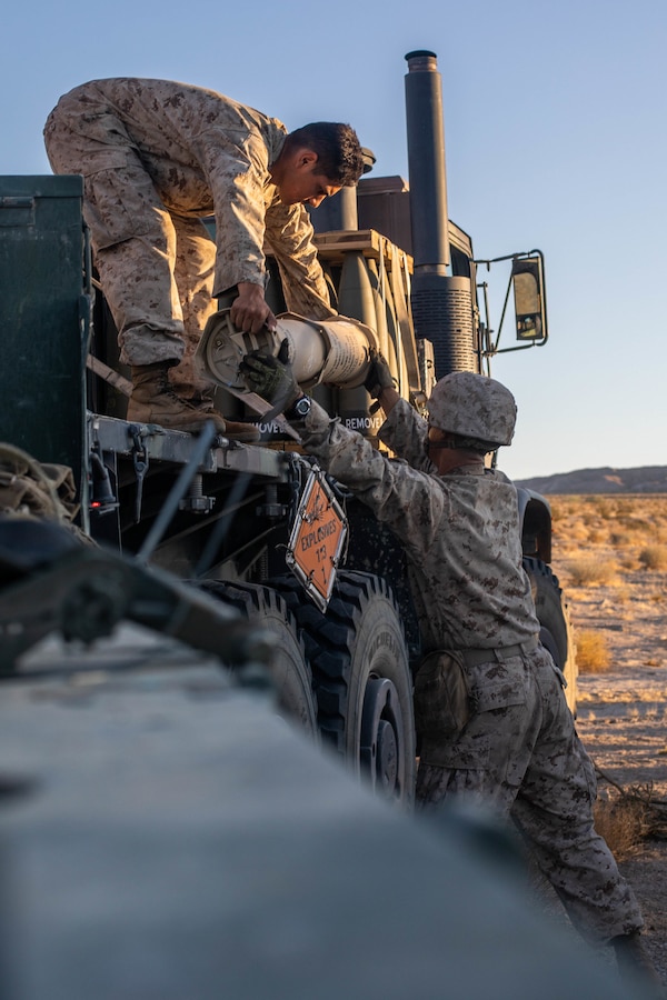 Marines with Oscar Battery, 5th Battalion, 14th Marines, 4th Marine Division, unload ammunition during Integrated Training Exercise (ITX) 4-21 at Marine Corps Air Ground Combat Center Twentynine Palms, California on July 27, 2021. Reserve Marines and Sailors have come together from across the country as an integrated Marine Air-Ground Task Force to take part in a live-fire, combined arms exercise that will better prepare Marine Forces Reserve in its mission to augment and reinforce the Active Component. (U.S Marine Corps photo by Lance Cpl. David Intriago)