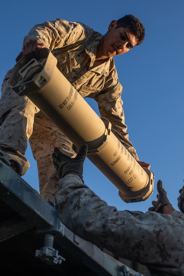 Marines with Oscar Battery, 5th Battalion, 14th Marines, 4th Marine Division, unload ammunition during Integrated Training Exercise (ITX) 4-21 at Marine Corps Air Ground Combat Center Twentynine Palms, California on July 27, 2021. Reserve Marines and Sailors have come together from across the country as an integrated Marine Air-Ground Task Force to take part in a live-fire, combined arms exercise that will better prepare Marine Forces Reserve in its mission to augment and reinforce the Active Component. (U.S Marine Corps photo by Lance Cpl. David Intriago)