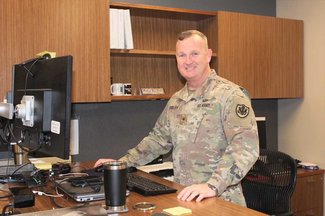 Army Brigadier General Eric Shirley stands at his desk