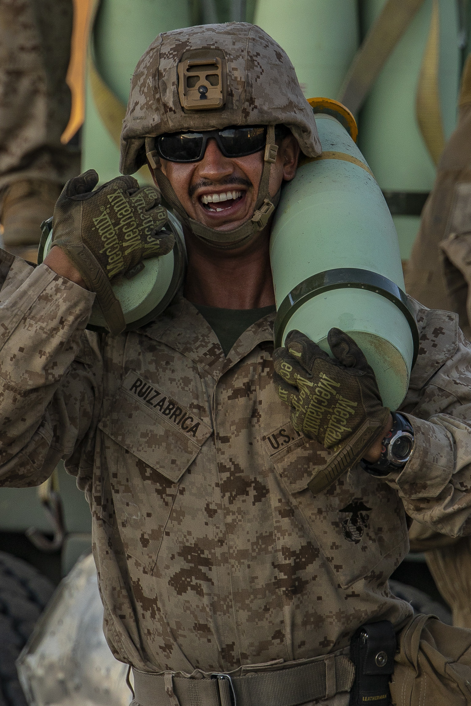 Cpl. Jesus Ruizabrica, an assistant gunner with Oscar Battery, 5th Battalion, 14th Marines unloads ammunition during Integrated Training Excercise (ITX) 4-21 at Marine Corps Air Ground Combat Center Twentynine Palms, California on July 27, 2021. Reserve Marines and Sailors have come together from across the country as an integrated Marine Air-Ground Task Force to take part in a live-fire, combined arms exercise that will better prepare Marine Forces Reserve in its mission to augment and reinforce the Active Component. (U.S. Marine Corps photo by Lance Cpl. Samwel Tabancay)
