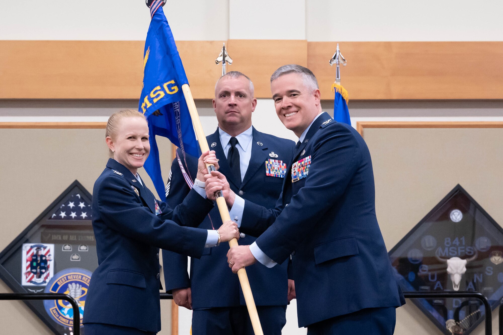 Col. Christopher Karns, right, accepts command of the 341st Mission Support Group from Col. Anita Feugate Opperman, 341st Missile Wing commander, during a change of command ceremony July 28, 2021, at Malmstrom Air Force Base, Mont.