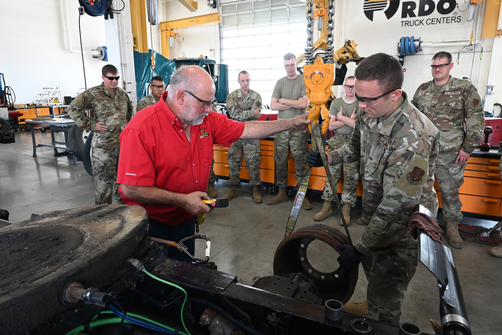 Air brake systems instructor Jim Bainer, red shirt, directs Airman 1st Class Mason Heimkes, of the 119th Logistics Readiness Squadron, as he provides instruction for Air National Guard students in the ‘lab’ training at Minnesota State Community College (M State), Moorhead, Minn., July 22, 2021.