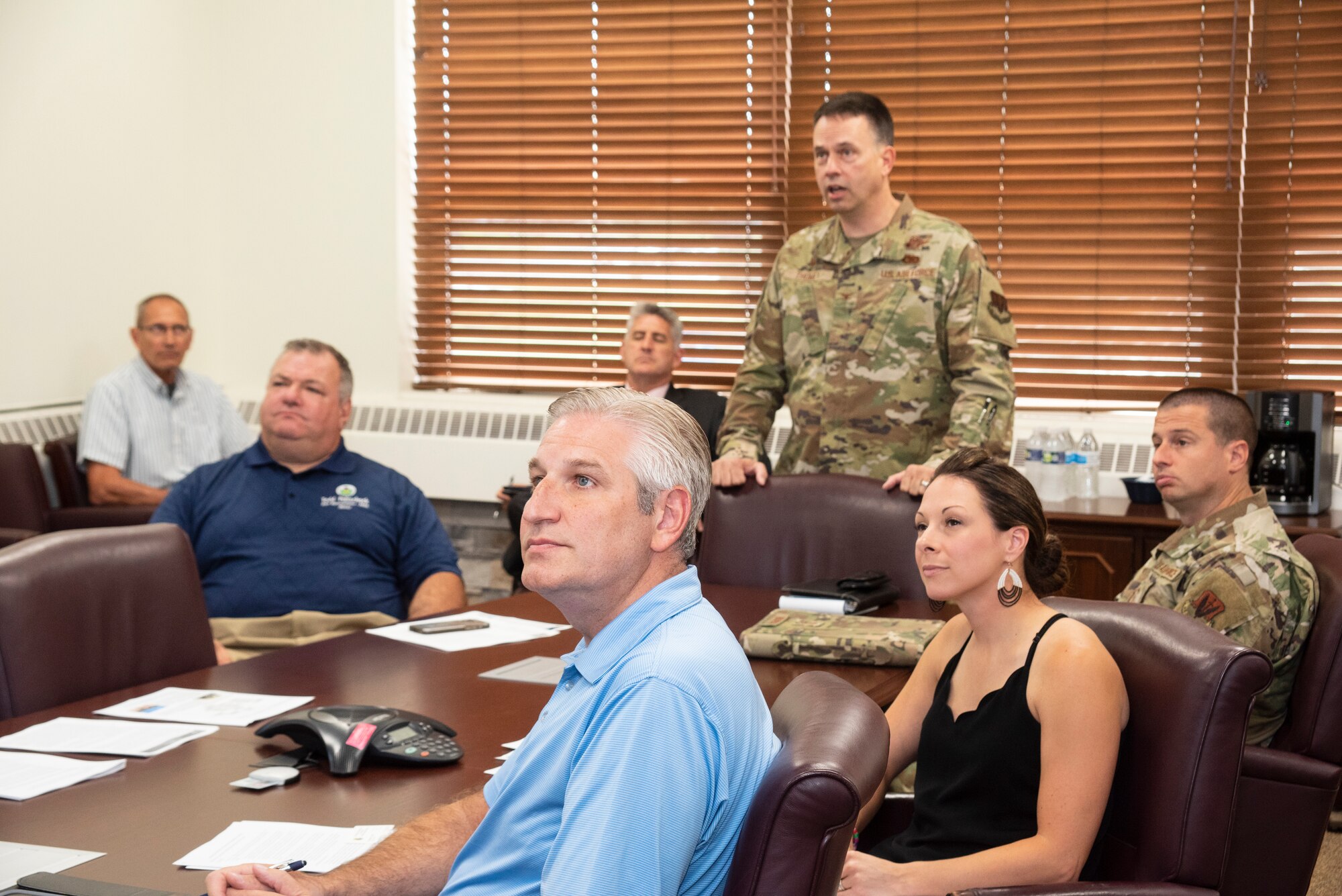 An Air National Guard colonel briefs a room of civilians.