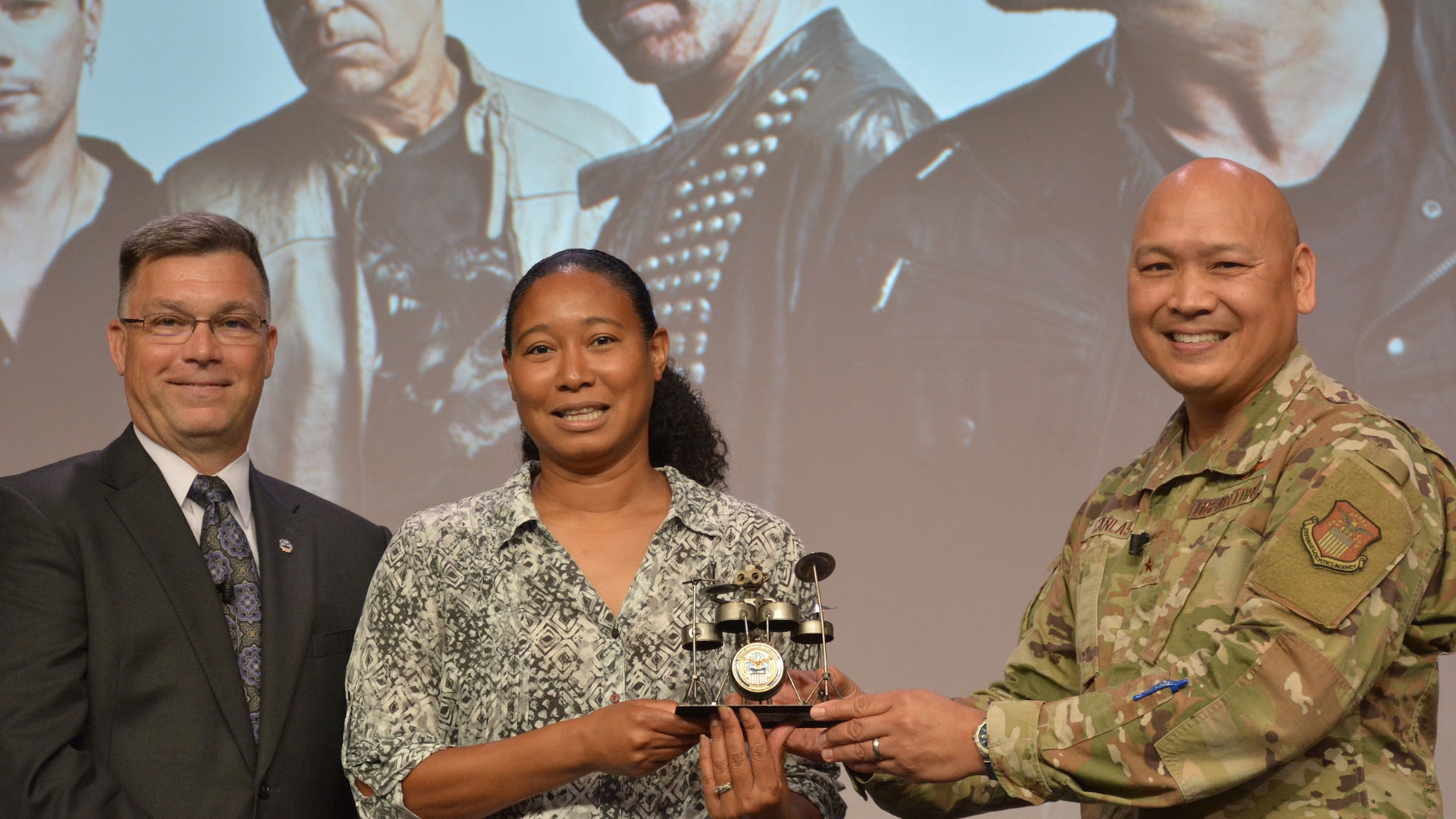 Three people on a stage