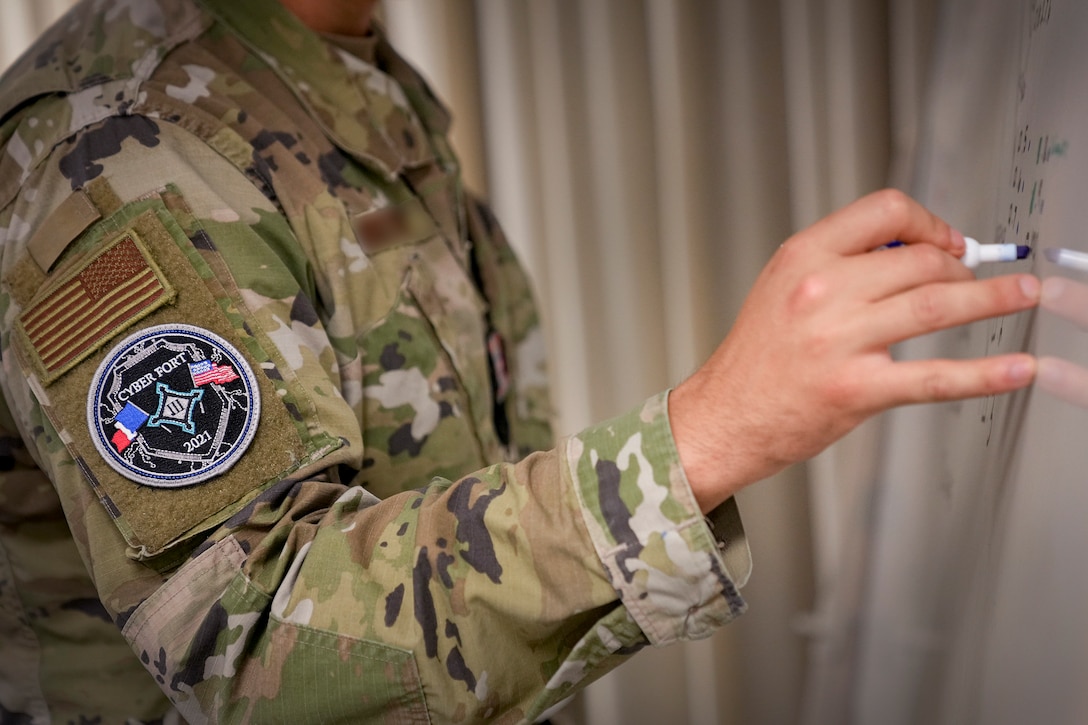 A U.S. Cyber Command cyber warrior takes notes on a whiteboard during the training exercise, Cyber Fort III, at Fort George G. Meade, Md., July 21, 2021.