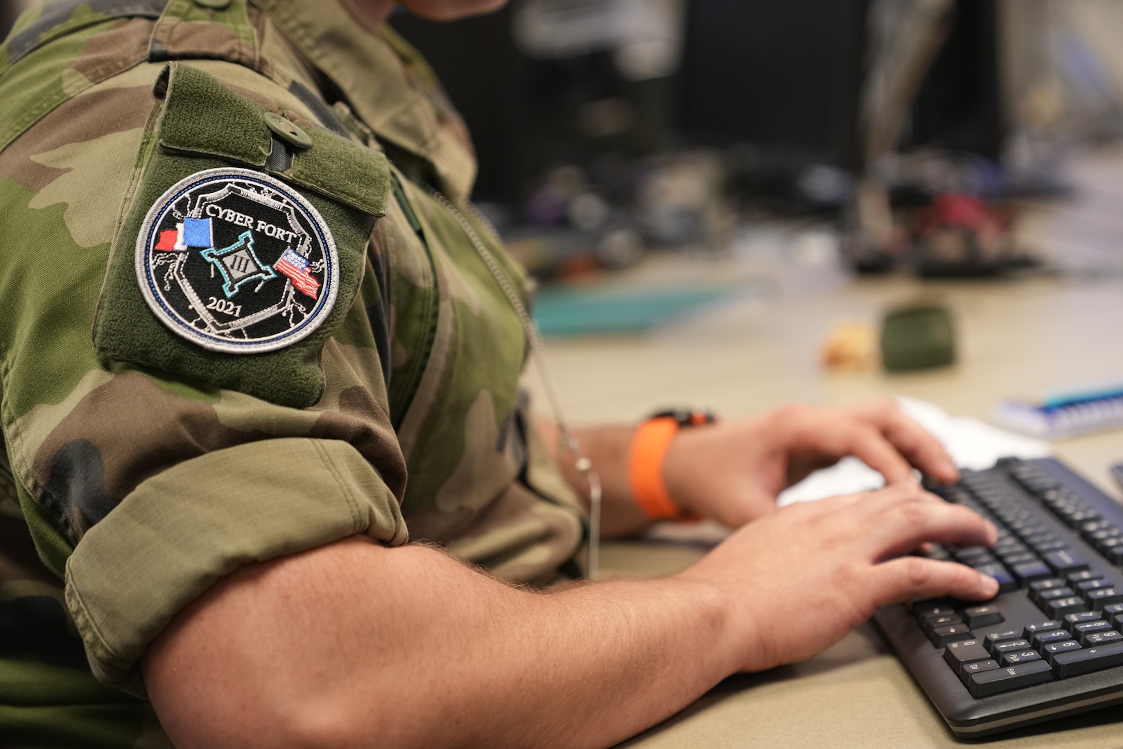A French cyber warrior types during the U.S. Cyber Command training exercise, Cyber Fort III, at Fort George G. Meade, Md., July 21, 2021.