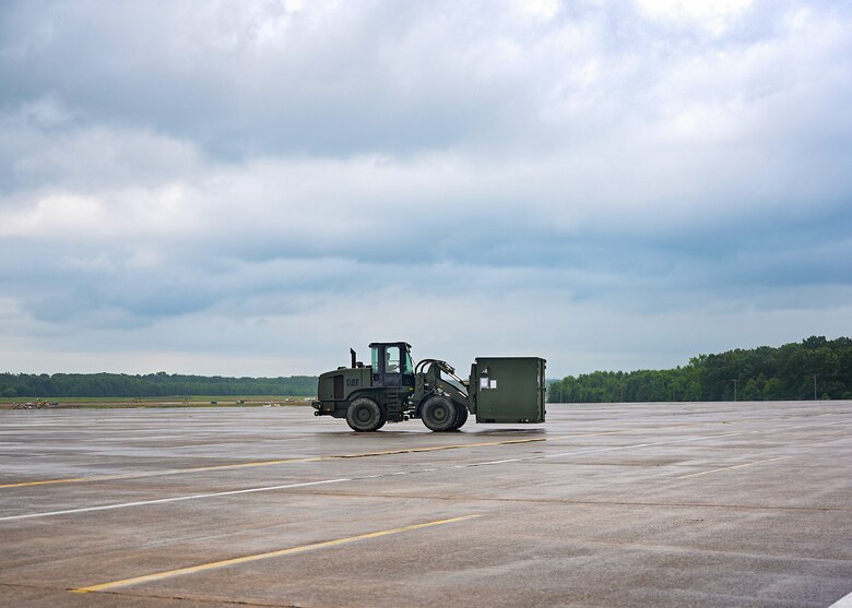 An Airman assigned to the 19th Logistics Readiness Squadron uses a forklift to transport cargo to a C-130J Super Hercules