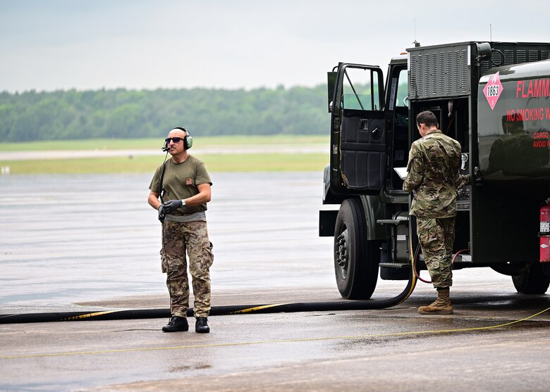 A member of the Italian air force watches as an aircraft receives fuel