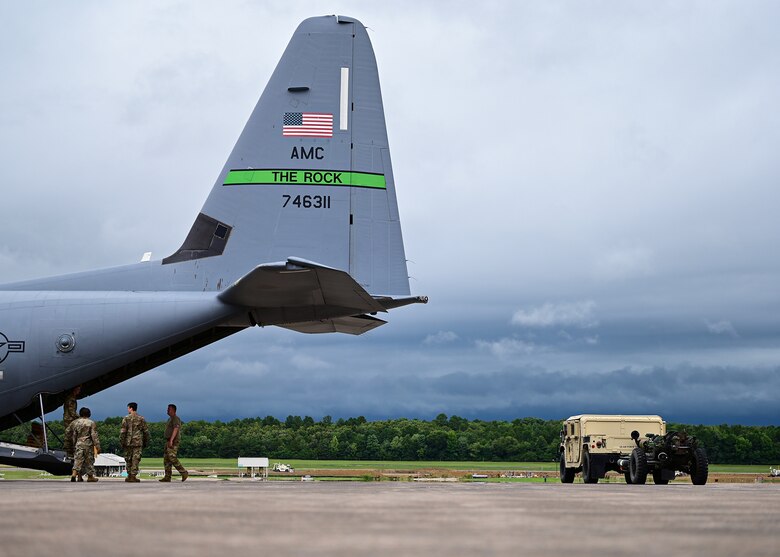 Airmen assigned to the 19th Airlift Wing prepare to load a High Mobility Multipurpose Wheeled Vehicle into a C-130J Super Hercules