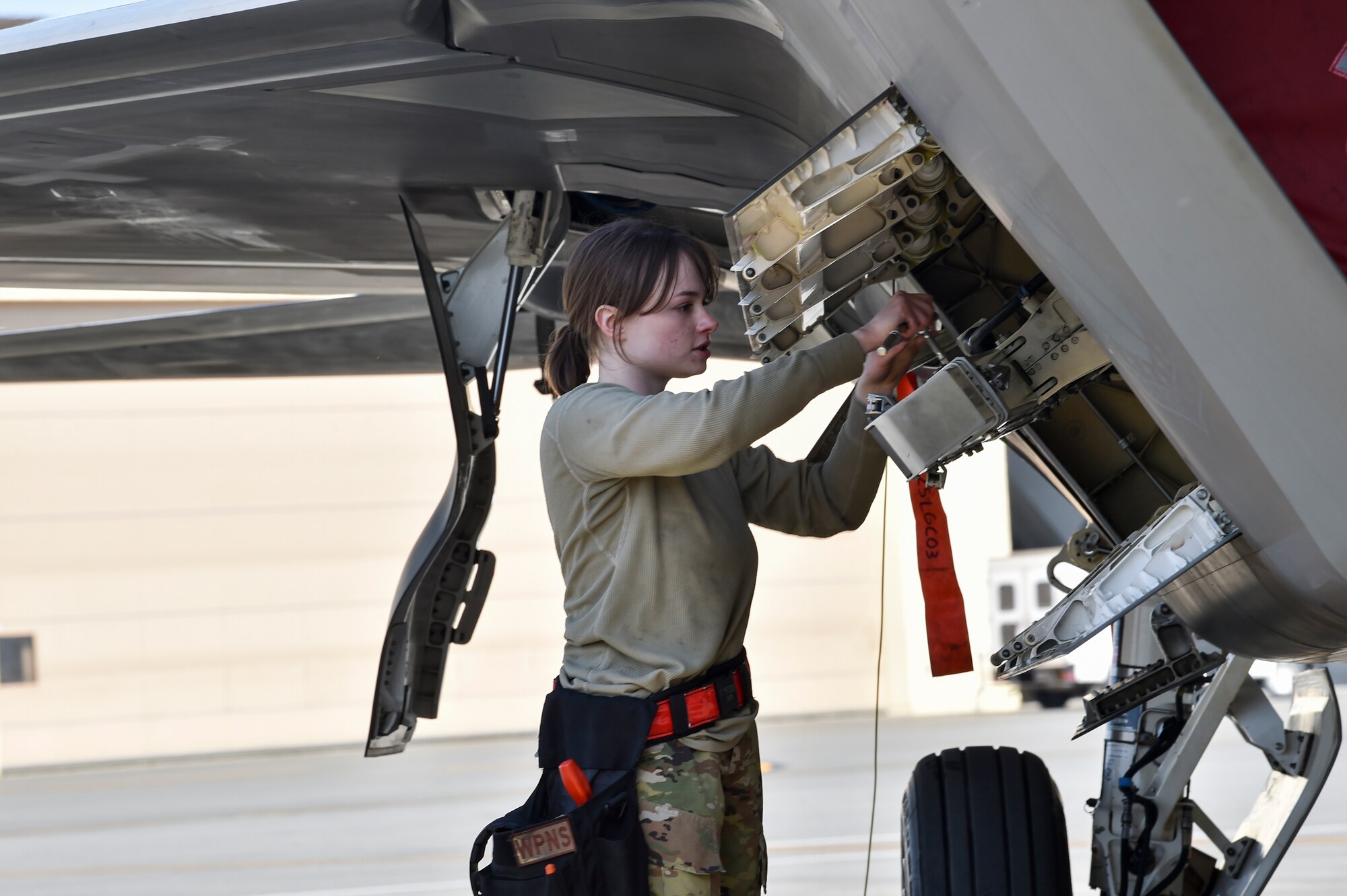U.S. Air Force Airman 1st Class Caroline Peters, a 90th Aircraft Maintenance Unit weapons load crew member, performs launcher preparation during a Weapons Load Crew of the Quarter competition at Joint Base Elmendorf-Richardson, Alaska, July 1, 2021. Airmen from the 525th and 90th Aircraft Maintenance Units competed for the title of the 3rd Maintenance Group Load Crew of the Quarter.