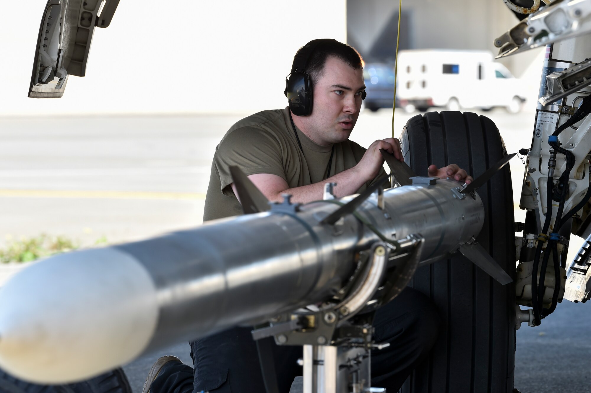 U.S. Air Force Staff Sgt. Jon Menghini, a 90th Aircraft Maintenance Unit weapons load crew chief, secures an AIM-120 missile during a Weapons Load Crew of the Quarter competition at Joint Base Elmendorf-Richardson, Alaska, July 1, 2021. Airmen from the 525th and 90th Aircraft Maintenance Units competed for the title of the 3rd Maintenance Group Load Crew of the Quarter.