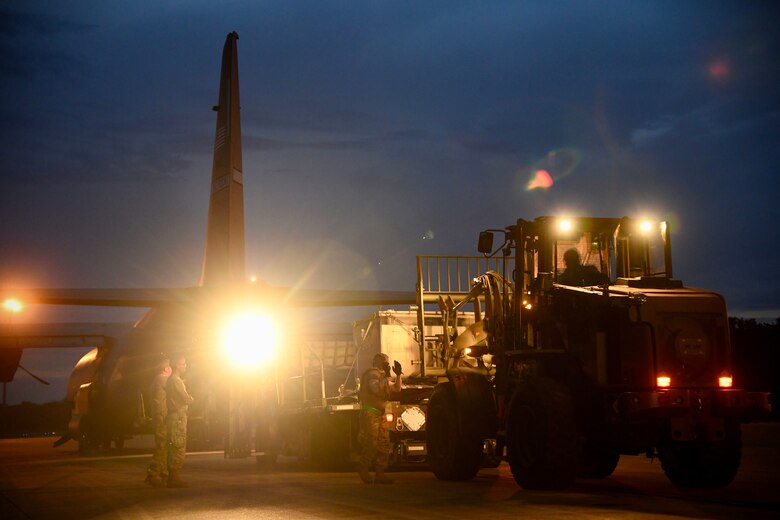 Airmen from the 821st Contingency Response Squadron load cargo onto a C-130J Super Hercules