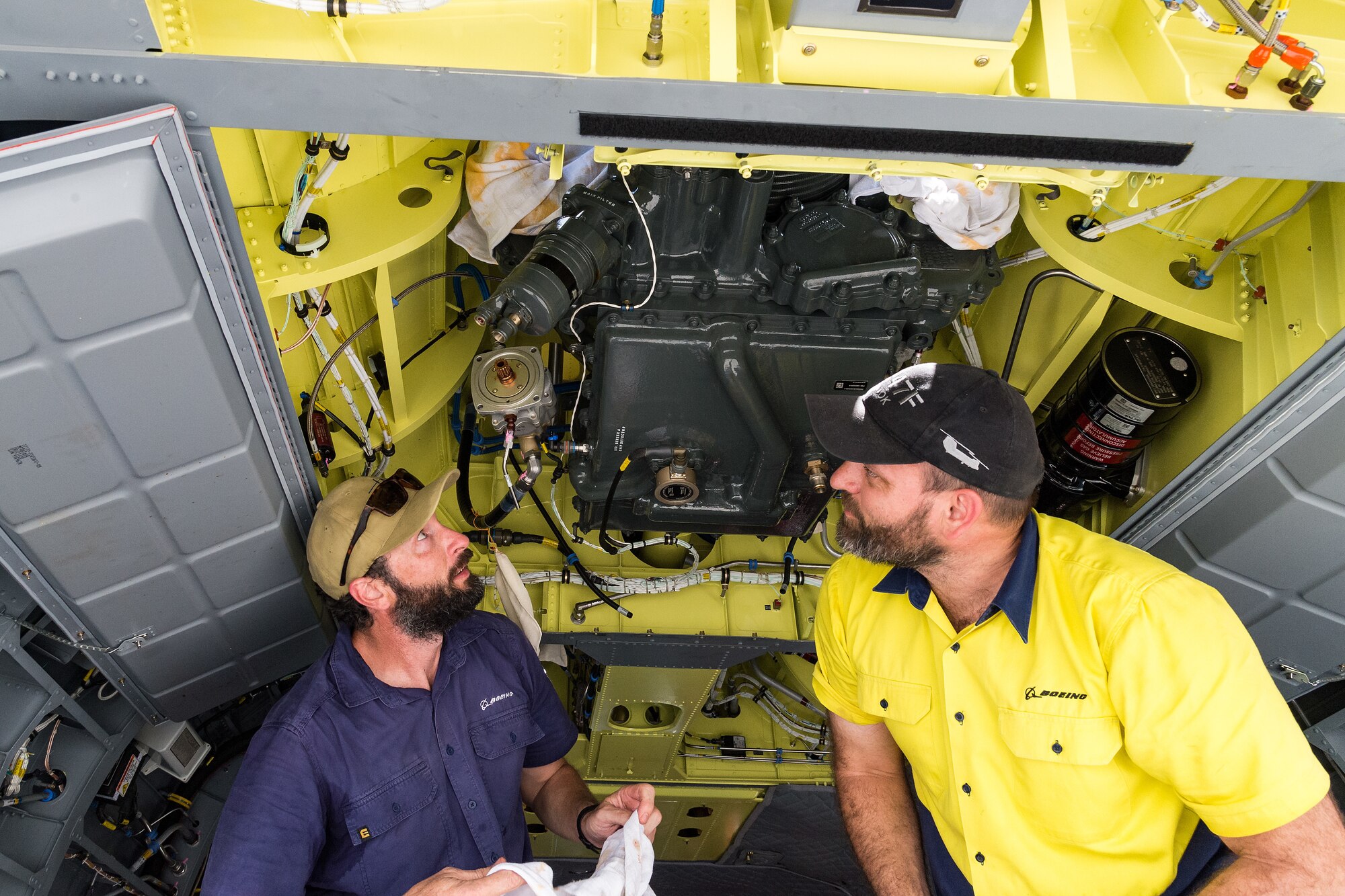 Boeing Defence Australia maintenance team members prepare a CH-47F Chinook helicopter rear transmission for removal at Dover Air Force Base, Delaware, June 8, 2021. BDA maintenance personnel readied two Chinooks for shipment aboard a C-5M Super Galaxy as part of the U.S. government’s foreign military sales program. The U.S.-Australia alliance is an anchor for peace and stability in the Indo-Pacific region and around the world. (U.S. Air Force photo by Roland Balik)