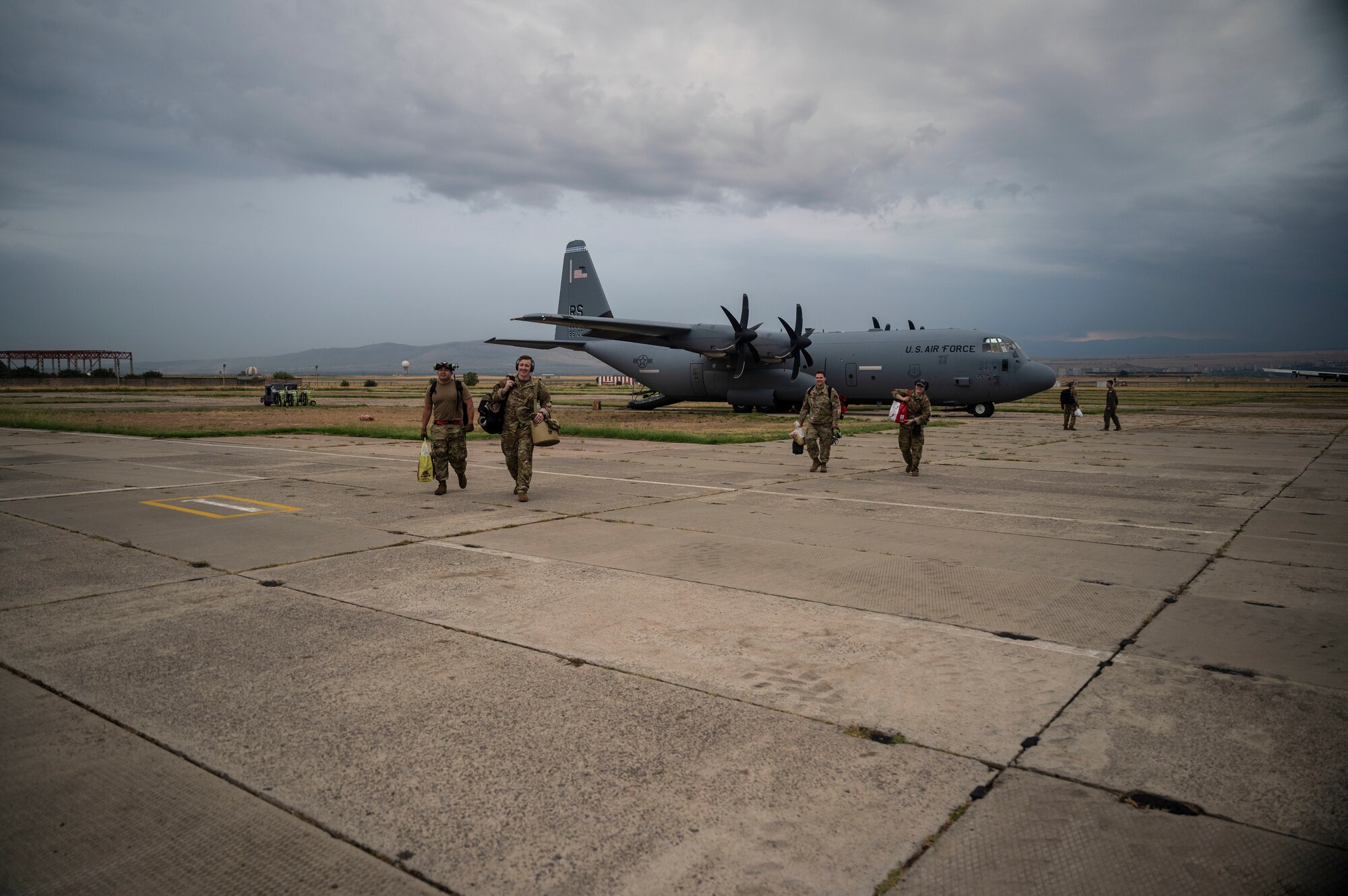U.S. Air Force Airmen assigned to Ramstein Air Base, Germany, walk across the flight line during exercise Agile Spirit 21