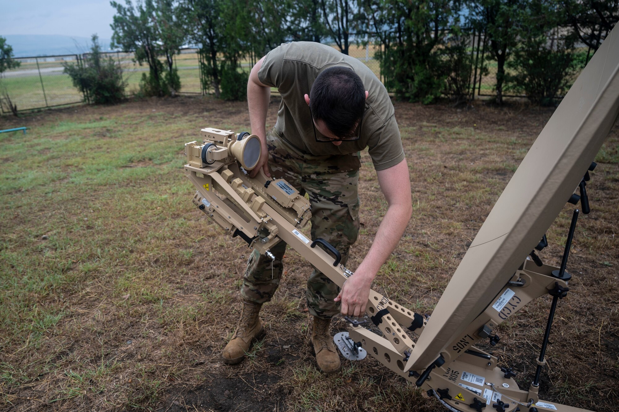 U.S. Air Force Airman First Class Isaac Peebles, 1st Combat Communications Squadron radio frequency transmission systems, builds a tactical satellite during exercise Agile Spirit 21