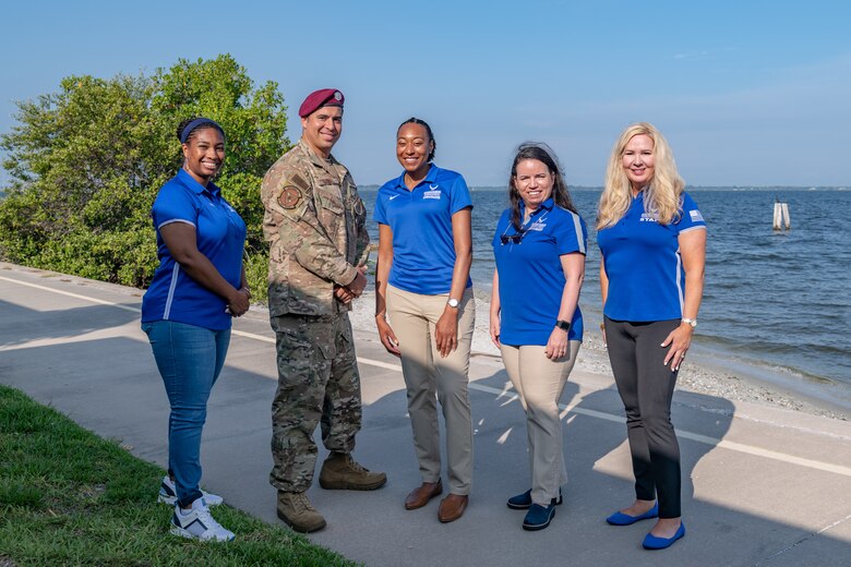 From left to right, Retired U.S. Air Force Master Sgt. Angela Alveo-Forbes, Tech. Sgt. August O'Niell, 414th Combat Training Squadron Detachment 1 flight chief in charge of ground operations, Maj. Marie Perkins, 633rd Medical Support Squadron chief information officer and information systems flight commander, Retired Chief Master Sgt. Ruth Urbina, and Melissa Wiest, Air Force Wounded Warrior program outreach and ambassador coordinator, stand outside the Riverside Dining Facility at July 28, 2021, at Patrick Space Force Base, Florida. The group visited Patrick SFB and Cape Canaveral Space Force Station to share their stories of resilience. (U.S. Space Force photo by Joshua Conti)