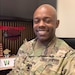 man sitting at a desk smiling