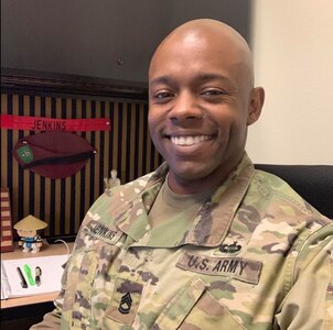 man sitting at a desk smiling