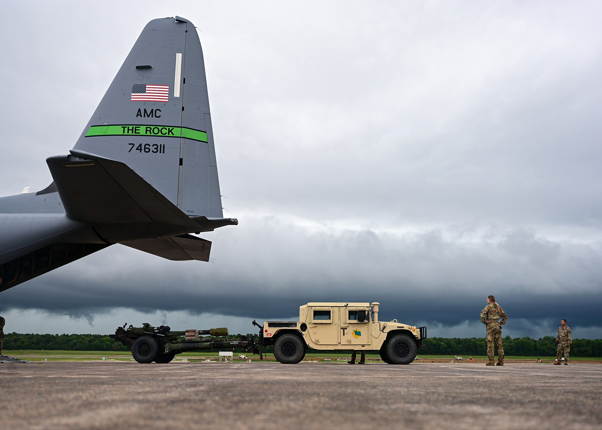 Airmen assigned to the 19th Airlift Wing prepare to load a High Mobility Multipurpose Wheeled Vehicle into a C-130J Super Hercules