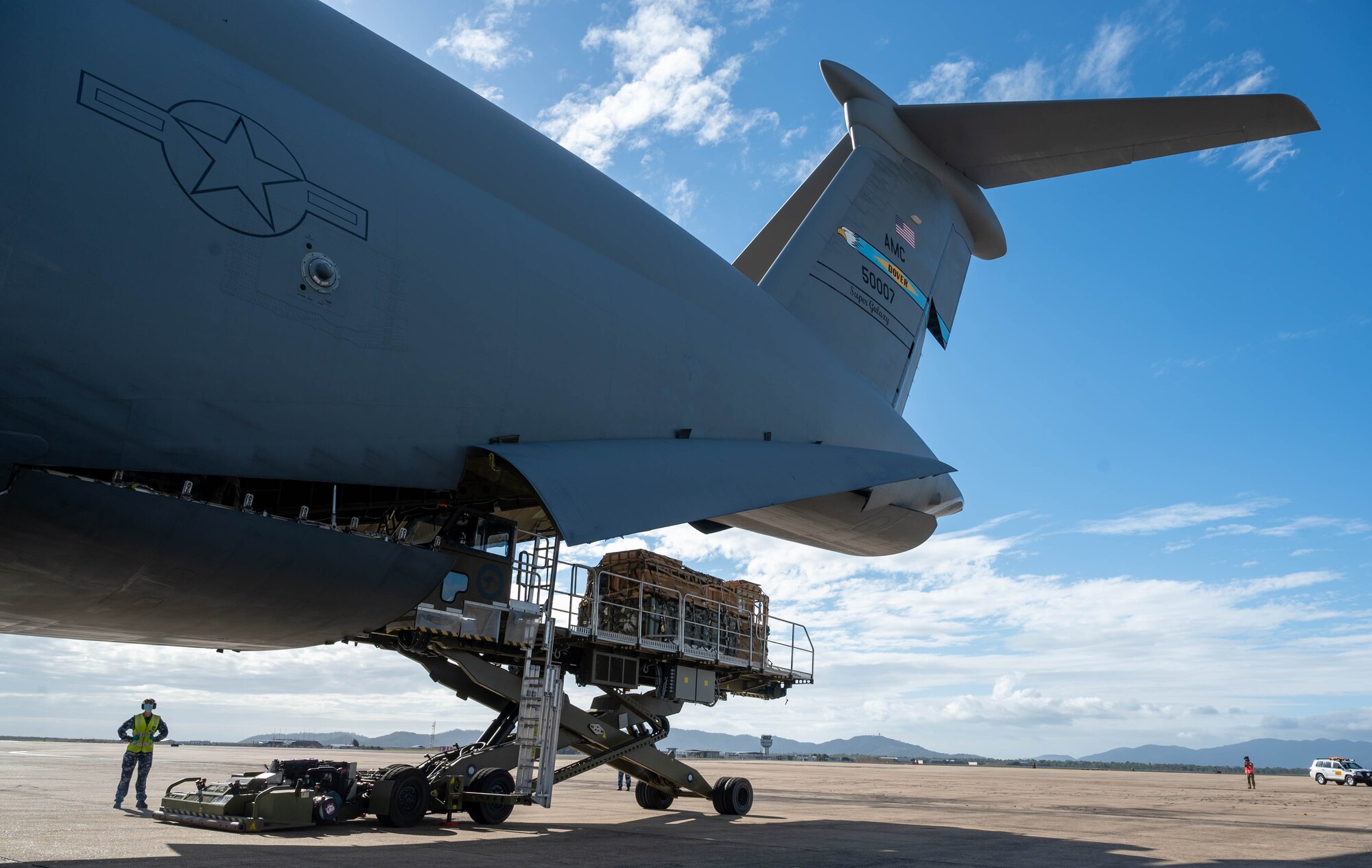 Cargo is unloaded from a Dover Air Force Base C-5M Super Galaxy at Royal Australian Air Force Base Townsville, Australia, July 7, 2021. The C-5 transported two CH-47F Chinook helicopters to RAAF Base Townsville as a part of the Department of Defense’s Foreign Military Sales program. The U.S. and Australia maintain a robust relationship underpinned by shared democratic values, common interests and cultural bonds. The strong alliance is an anchor for peace and stability in the Indo-Pacific region and around the world. (U.S. Air Force photo by Senior Airman Faith Schaefer)