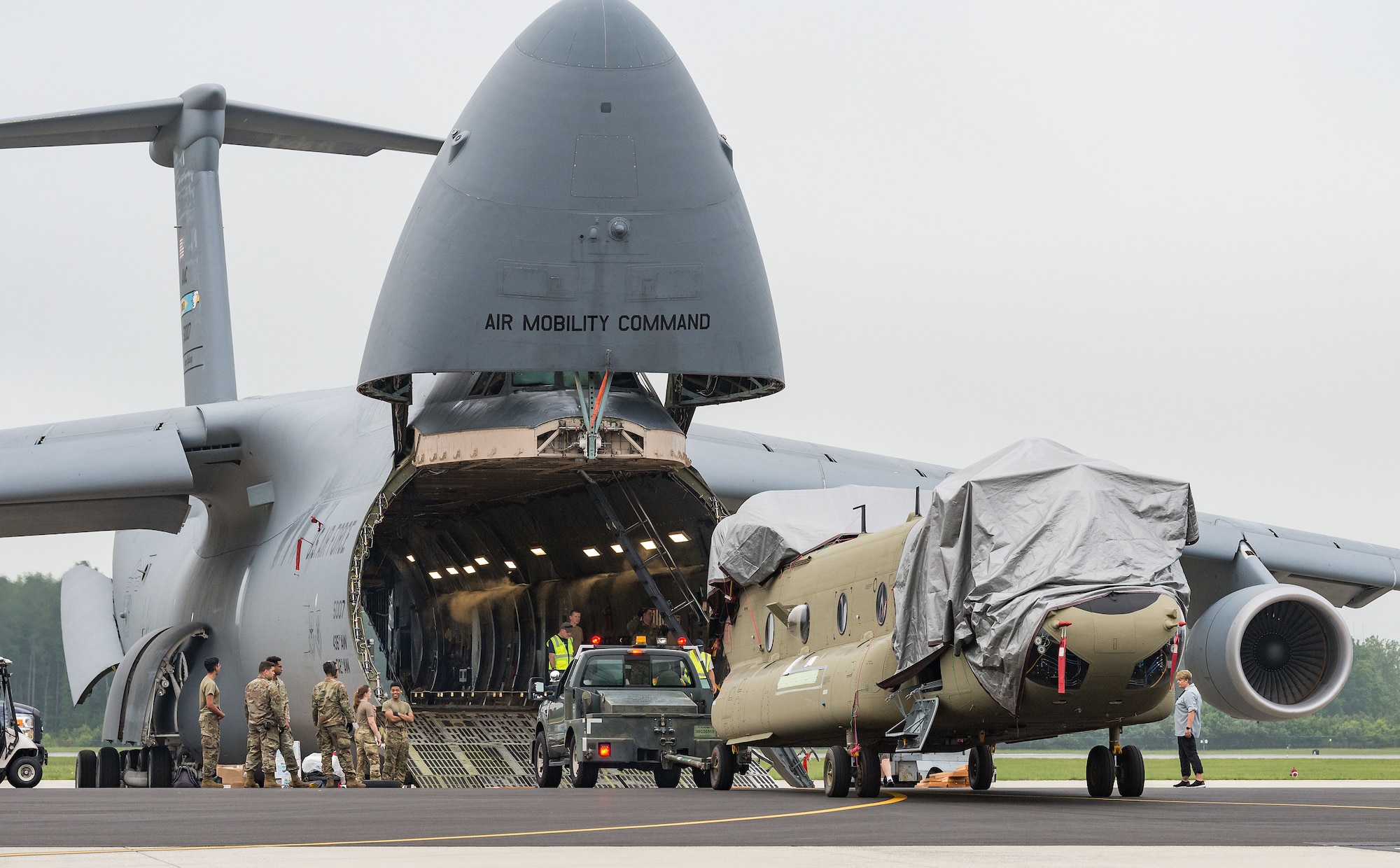 Boeing maintenance team members, 9th Airlift Squadron loadmasters and 436th Aerial Port Squadron ramp services personnel upload a CH-47F Chinook helicopter aboard a C-5M Super Galaxy at Dover Air Force Base, Delaware, June 26, 2021. Two Chinooks were loaded on the aircraft as part of the U.S. government’s foreign military sales program. The U.S.-Australia alliance is an anchor for peace and stability in the Indo-Pacific region and around the world. (U.S. Air Force photo by Roland Balik)