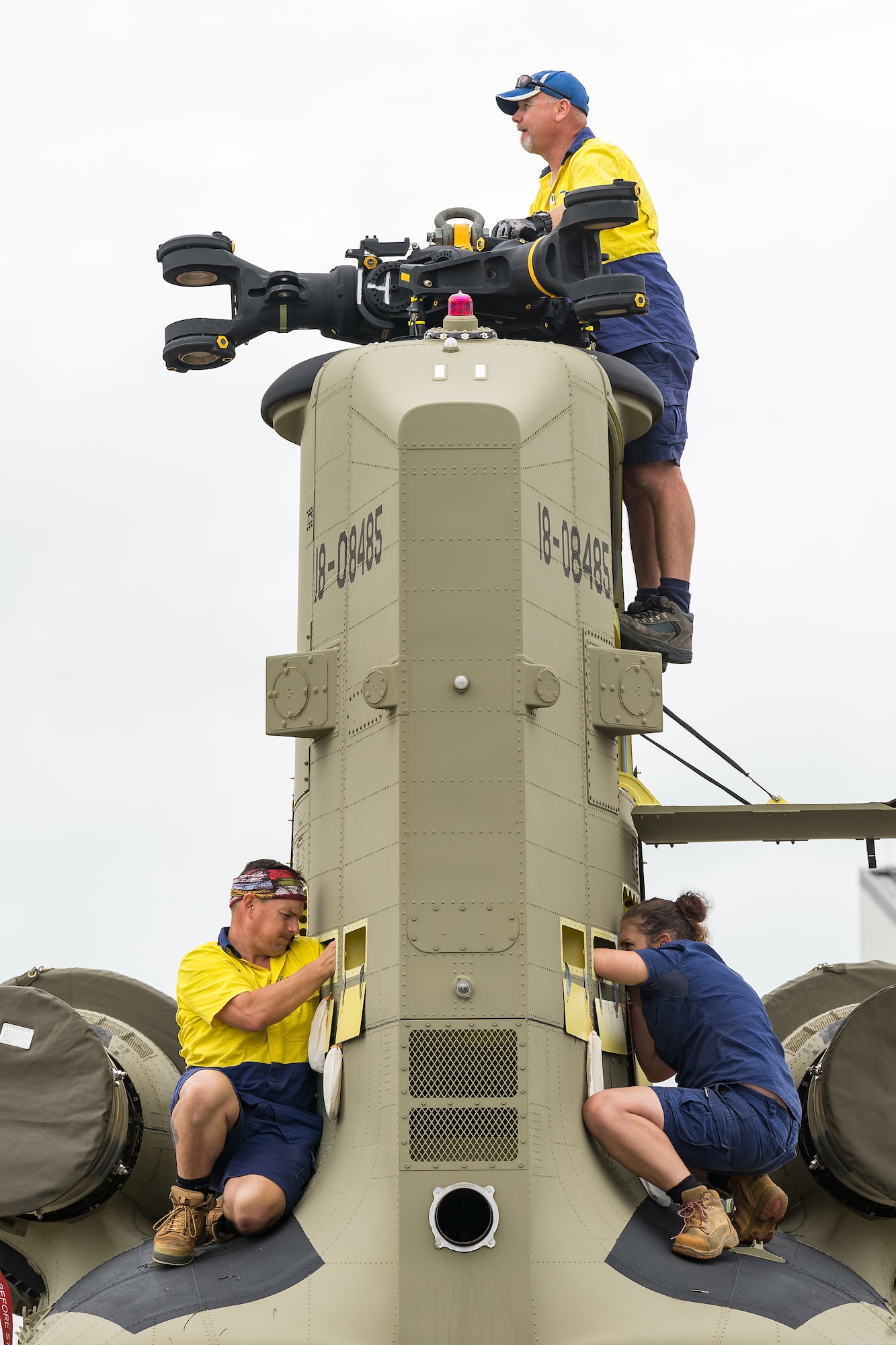 Boeing Defence Australia maintenance team members prepare the rear pylon and transmission on a CH-47F Chinook helicopter for removal  at Dover Air Force Base, Delaware, June 12, 2021. BDA maintenance personnel readied two Chinooks for shipment aboard a C-5M Super Galaxy as part of the U.S. government’s foreign military sales program. The U.S.-Australia alliance is an anchor for peace and stability in the Indo-Pacific region and around the world. (U.S. Air Force photo by Roland Balik)