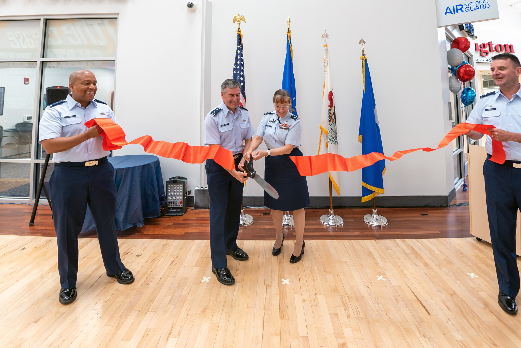 Airmen cutting ribbon.