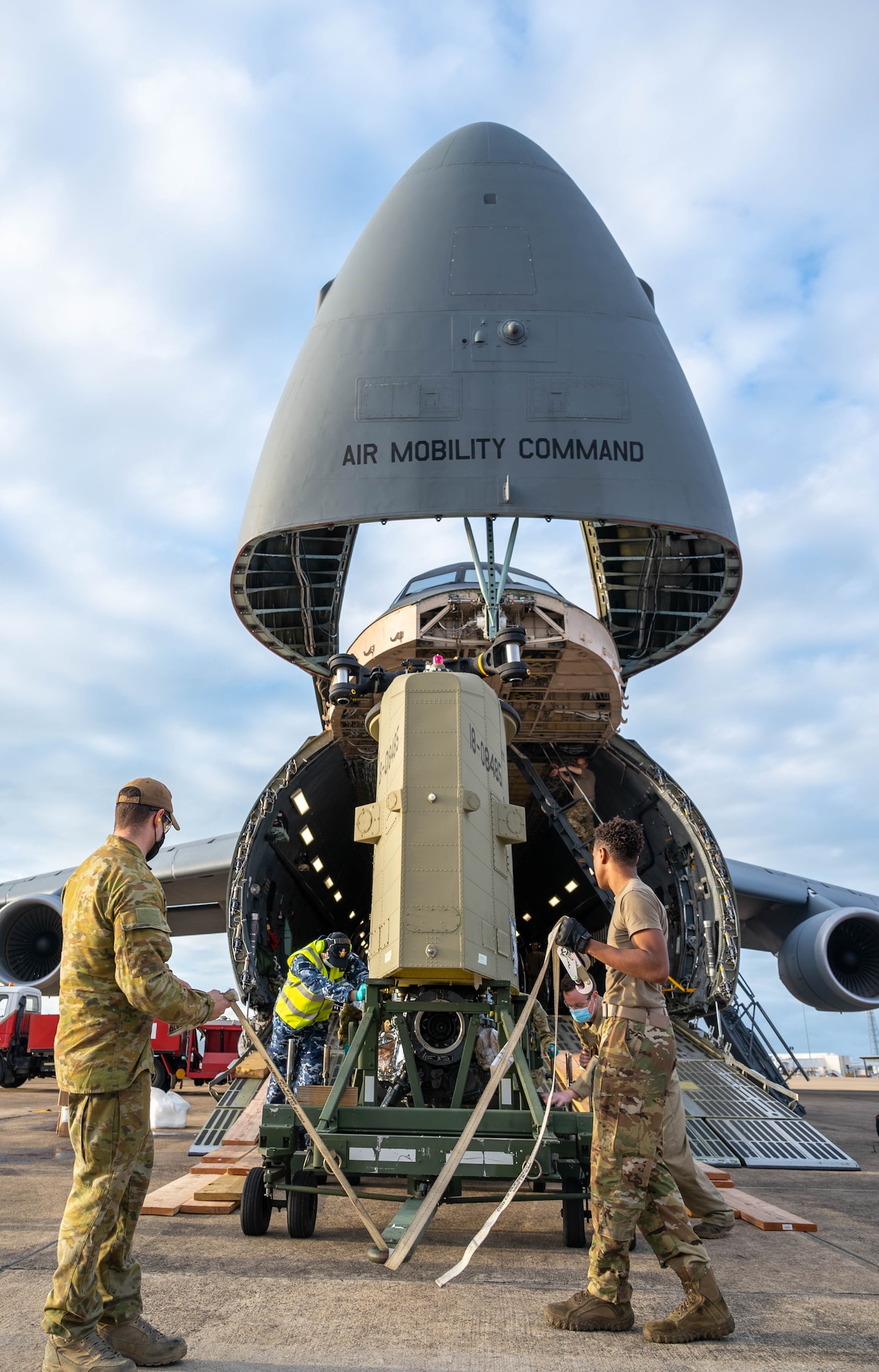 A CH-47F Chinook helicopter pylon is unloaded from a Dover Air Force Base C-5M Super Galaxy at Royal Australian Air Force Base, Townsville, Australia, July 7, 2021. The C-5 transported two CH-47F Chinook helicopters to RAAF Base Townsville as a part of the Department of Defense’s Foreign Military Sales program. The U.S. and Australia maintain a robust relationship underpinned by shared democratic values, common interests and cultural bonds. The strong alliance is an anchor for peace and stability in the Indo-Pacific region and around the world. (U.S. Air Force photo by Senior Airman Faith Schaefer)