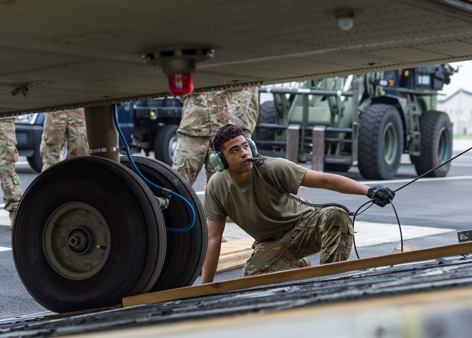 Senior Airman Damon Hutchins, 9th Airlift Squadron loadmaster, monitors a CH-47F Chinook helicopter as it is winched up the forward ramp of a C-5M Super Galaxy at Dover Air Force Base, Delaware, June 26, 2021. Team Dover personnel uploaded two Chinooks onto the aircraft as part of the U.S. government’s foreign military sales program. The U.S.-Australia alliance is an anchor for peace and stability in the Indo-Pacific region and around the world. (U.S. Air Force photo by Roland Balik)
