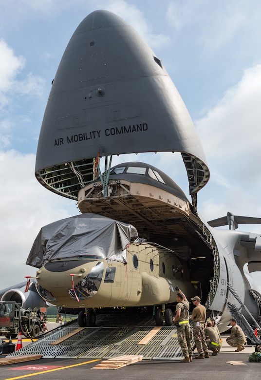 Boeing maintenance team members, 9th Airlift Squadron loadmasters and 436th Aerial Port Squadron ramp services personnel load a CH-47F Chinook helicopter onto a C-5M Super Galaxy at Dover Air Force Base, Delaware, June 26, 2021. Personnel uploaded two Chinooks onto the aircraft as part of the U.S. government’s foreign military sales program. The U.S.-Australia alliance is an anchor for peace and stability in the Indo-Pacific region and around the world. (U.S. Air Force photo by Roland Balik)