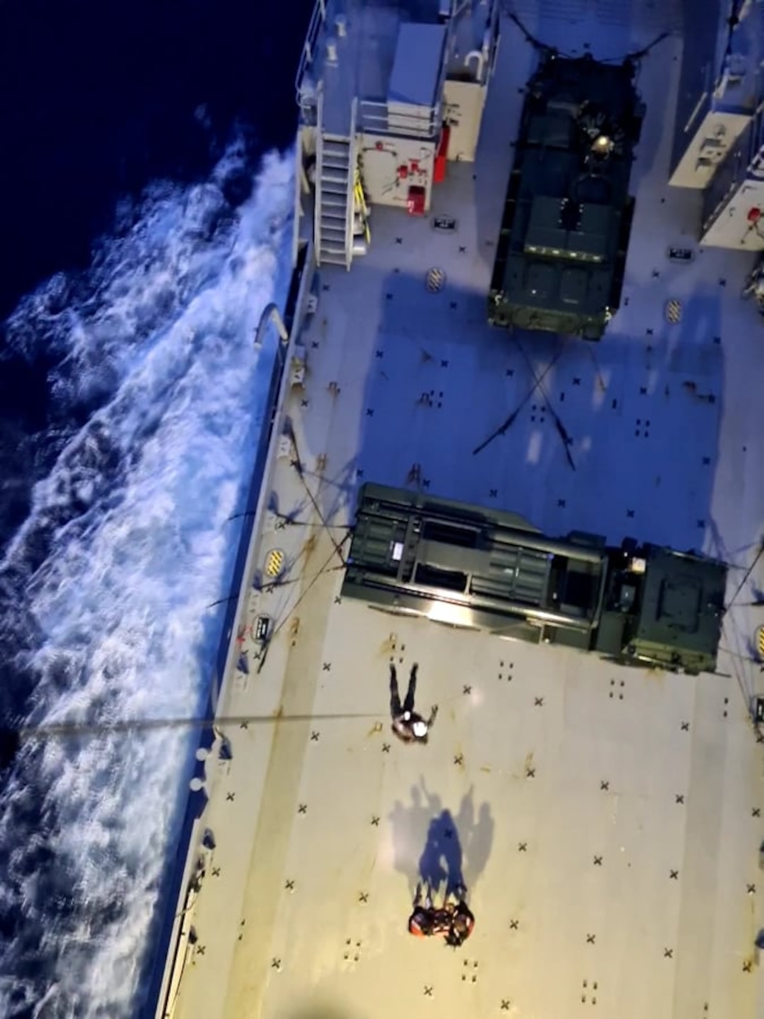 Members from U.S. Navy Helicopter Sea Combat Squadron Two-Five arrive on scene to an Army Watercraft System, where a U.S. Army Soldier sustained injuries and needed a medical evacuation in the Pacific Ocean, off the coast of Angaur, Palau, July 25, 2021. After the Soldier was injured while at sea during Exercise Forager 21, members from U.S. Air Force, U.S. Navy, U.S. Coast Guard worked together to provide lifesaving assistance to the Solider.